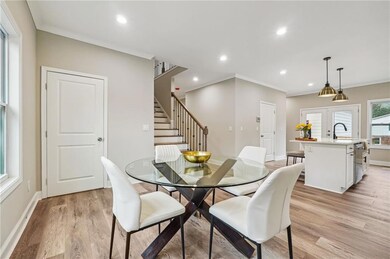 Dining space with french doors, stairs, crown mold