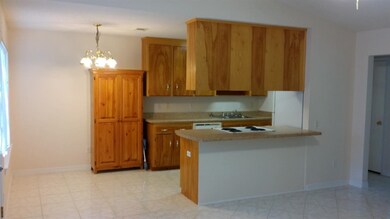Kitchen looks out to living room