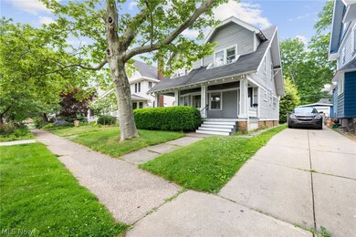 View of front of property with a porch and a front lawn
