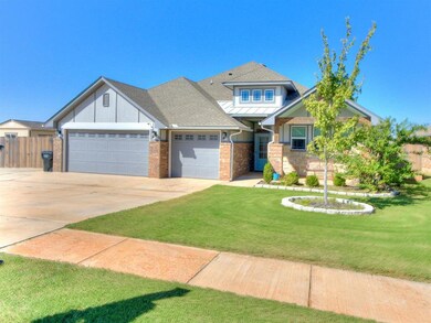 Craftsman-style house with a shingled roof, a garage, driveway, brick siding, and board and batten siding
