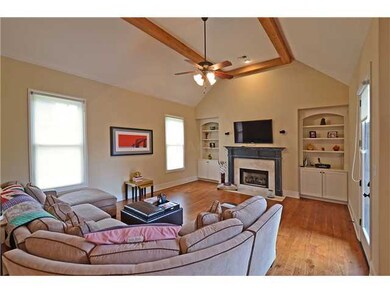 This cozy Hearth Room off the Kitchen features har