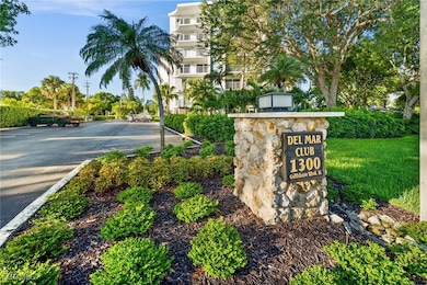 Community sign featuring uncovered parking