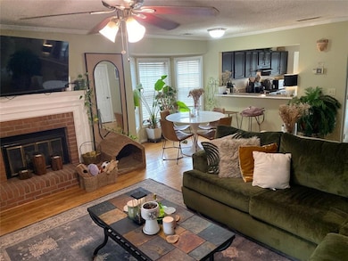 Vview of fam rm, kitchn with pass thru plus bar.