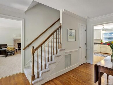 Foyer complete with lovely hardwood floors, crown 
