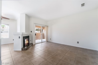 Unfurnished living room featuring tile patterned f