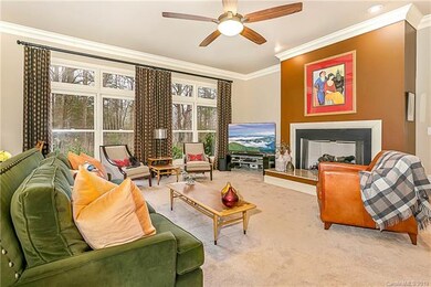 beautiful, open, bright living room features large fireplace that can be either gas or wood burning. Newer carpets and large windows looking out onto wooded and private backyard. Entire first floor is prewired for sound surround system