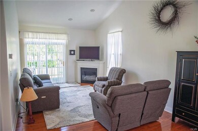Living room with vaulted ceiling, hardwood floors 