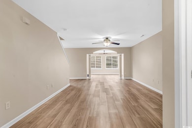 Unfurnished living room featuring ceiling fan, lig