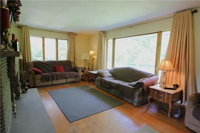 Another View of Large Living Room offering a Huge Front Picture Window plus a 2nd Oversized Window calling in the Natural Light!