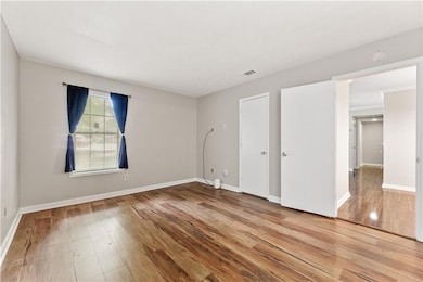 2nd bedroom with wood-style flooring, full bathroom