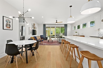 Dining room featuring a ceiling fan and light woo