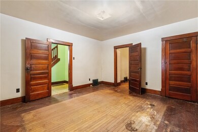 The living room has original hardwood flooring and