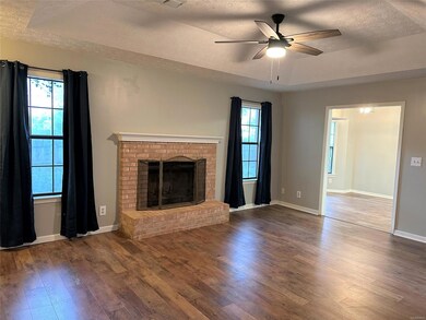Walk into the  living area featuring warm fireplac