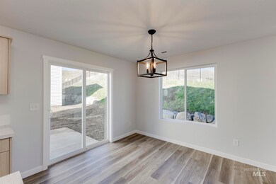 Unfurnished dining area featuring light wood-type flooring and a chandelier