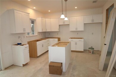 Ultra Modern Kitchen features white cabinetry, gra