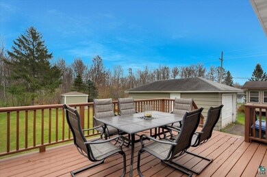 Deck featuring a storage unit and a yard
