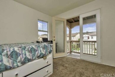 Another bedroom with a balcony view.