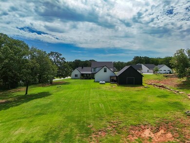 View of grassy yard with an outbuilding