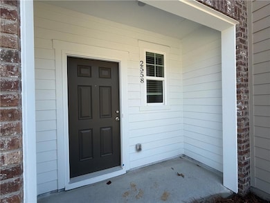View of exterior entry with a porch