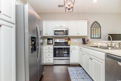 Kitchen with dark wood-type flooring, sink, white 