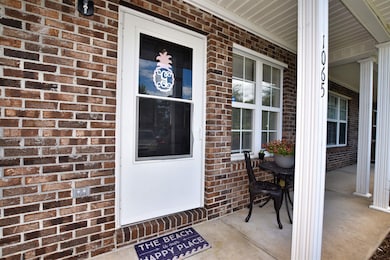 Property entrance with covered porch