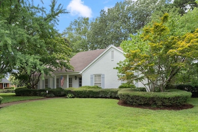 View of front of property featuring a front yard and roof with shingles