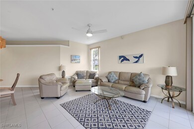 Living room featuring a ceiling fan and light tile