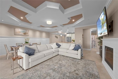 Living room featuring crown molding, coffered ceiling, light tile patterned floors, and recessed LED lighting