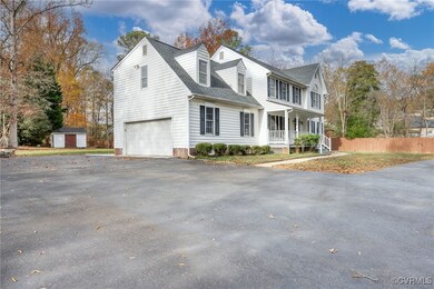View of front of property with a porch, a garage,