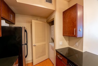 Kitchen with stacked washing maching and dryer, v