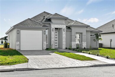 View of front of house with central AC unit, a garage, and a front lawn