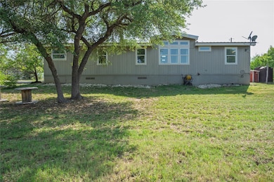 Rear view of property with a yard and crawl space
