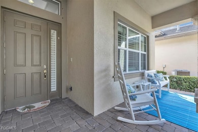 Doorway to property featuring stucco siding and covered porch