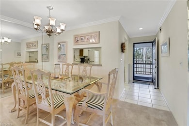 Dining room with a chandelier, crown molding, base