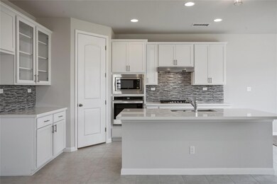 Kitchen featuring stainless steel appliances, tas