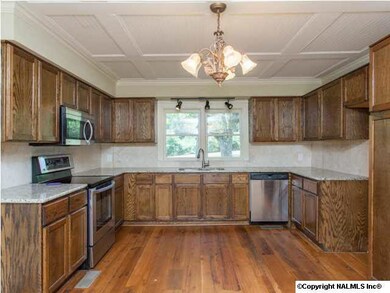 Kitchen with granite countertops, stainless appliances and low-profile coffered ceiling.