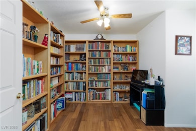 Living area featuring wall of books, wood finished