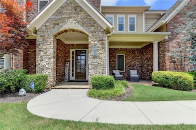 Property entrance with a porch and brick siding