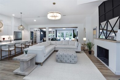 Living room with light LVP flooring and lofted cei
