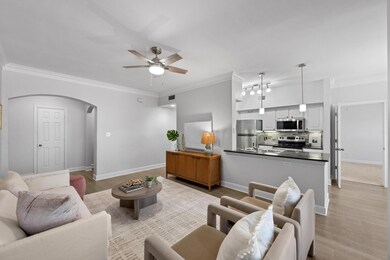 Living room with arched walkways, light wood-styl