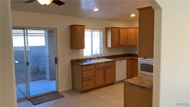 Kitchen with light tile patterned floors, white ap