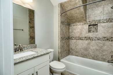 Full bathroom with washtub / shower combination and vanity