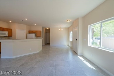 Unfurnished living room featuring a chandelier, re