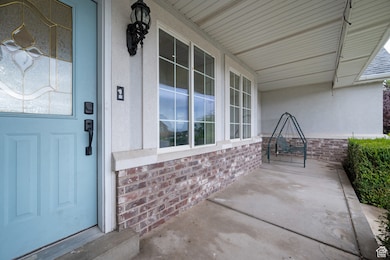 View of exterior entry featuring brick siding