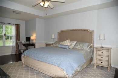Master bedroom with trey ceiling and sitting nook is on main level.