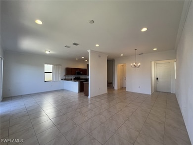 Unfurnished living room with crown molding, recessed lighting, a chandelier, and light tile patterned floors