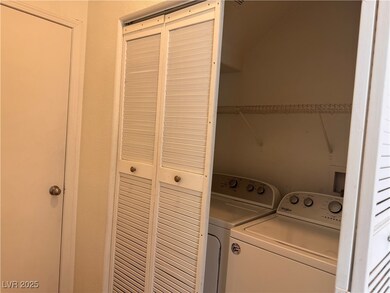 Washroom with laundry area and washer and clothes