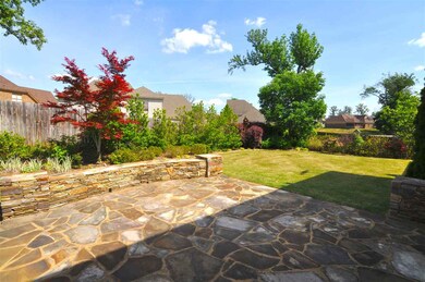 An extended stone patio is perfect for grilling ou