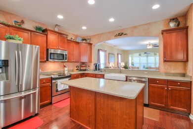 Island counter extends allows for bar stools. Island also adds more cabinets.   Large farmhouse sink.