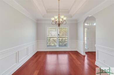 Formal Dining Room with coffered ceiling, wainscot